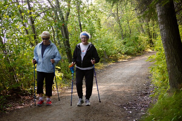 participants of outdoor walking group walk through park