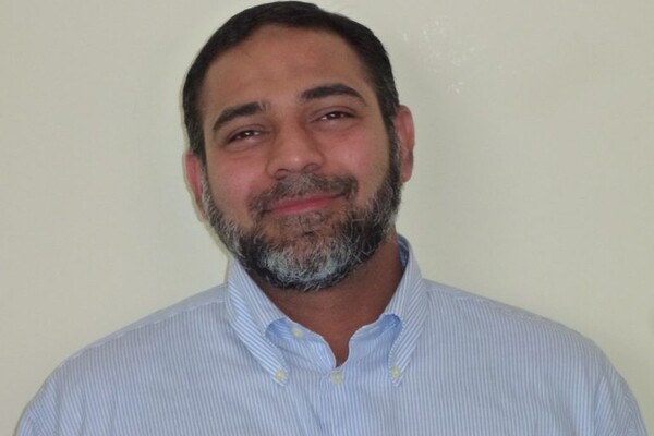 Salman Afzaal smiling at the camera