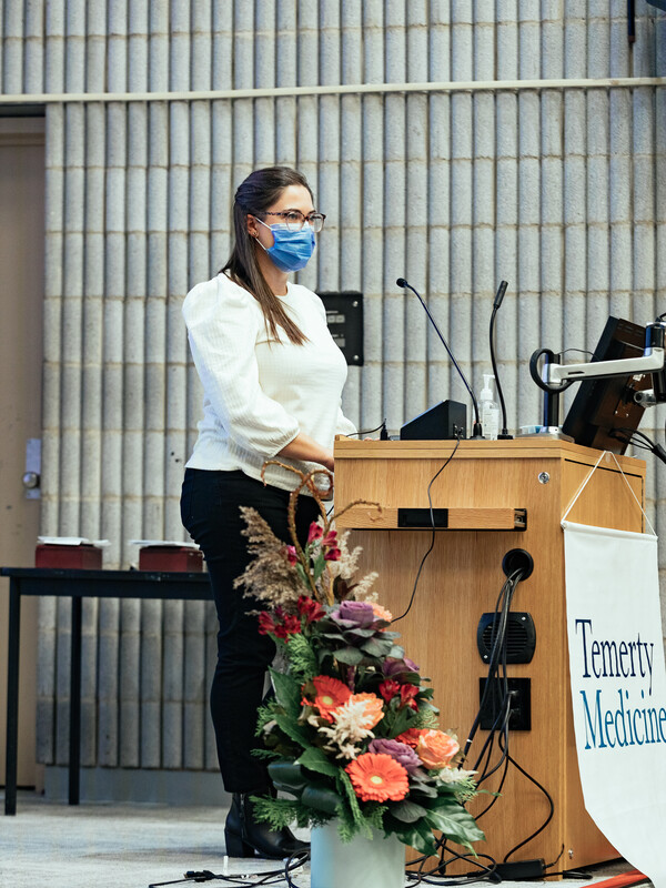 Maegan Bell standing at a podium.