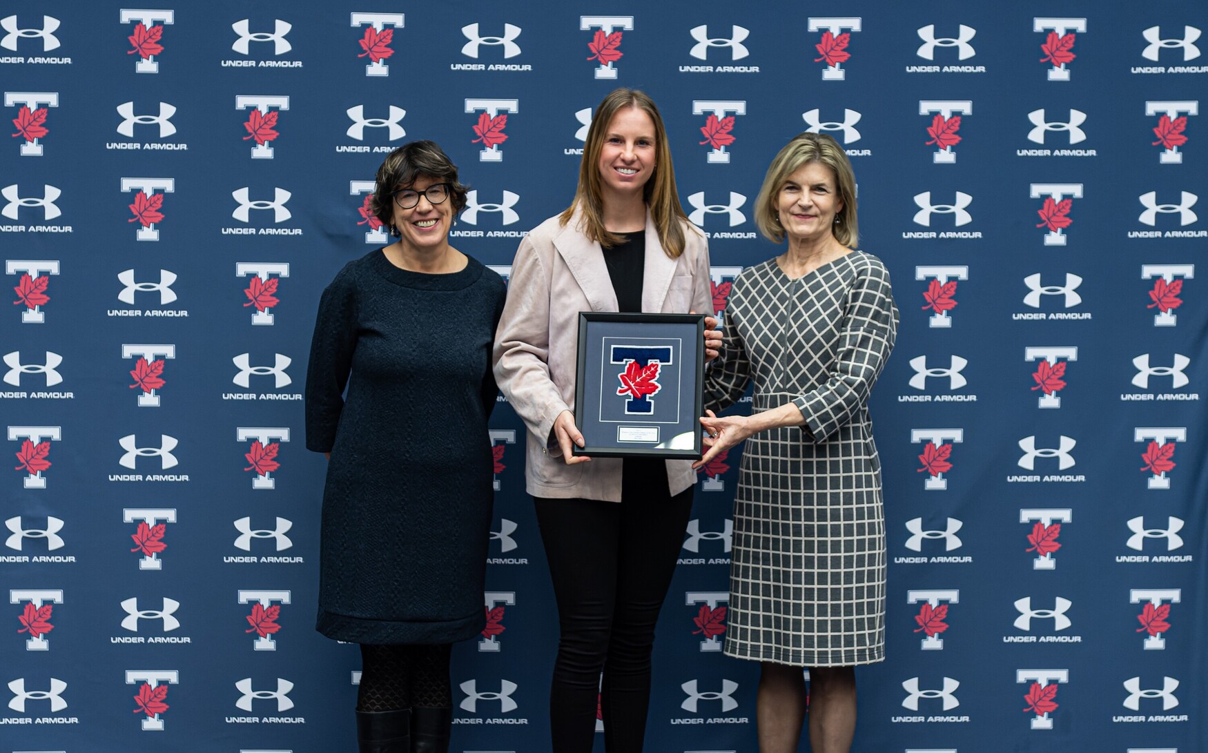 Katie Humhej poses with Ontario Top Scholar Athlete award with Sandy Welsh and Gretchen Kerr